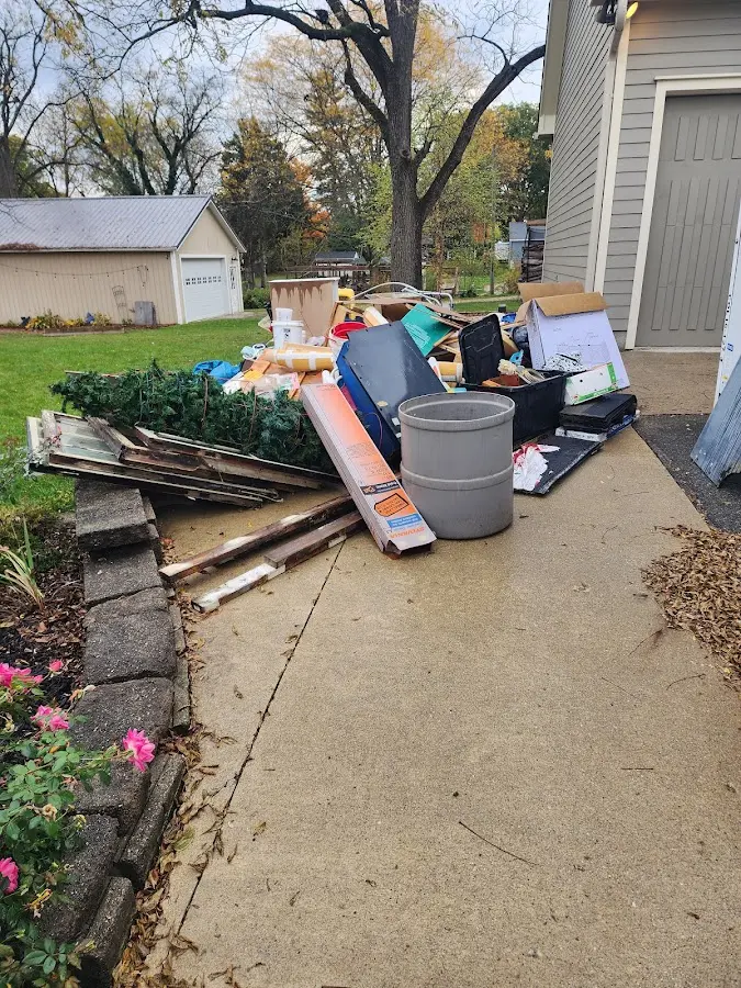 Dumpster being loaded with debris for Estate Cleanout Dumpster Rental in Carroll